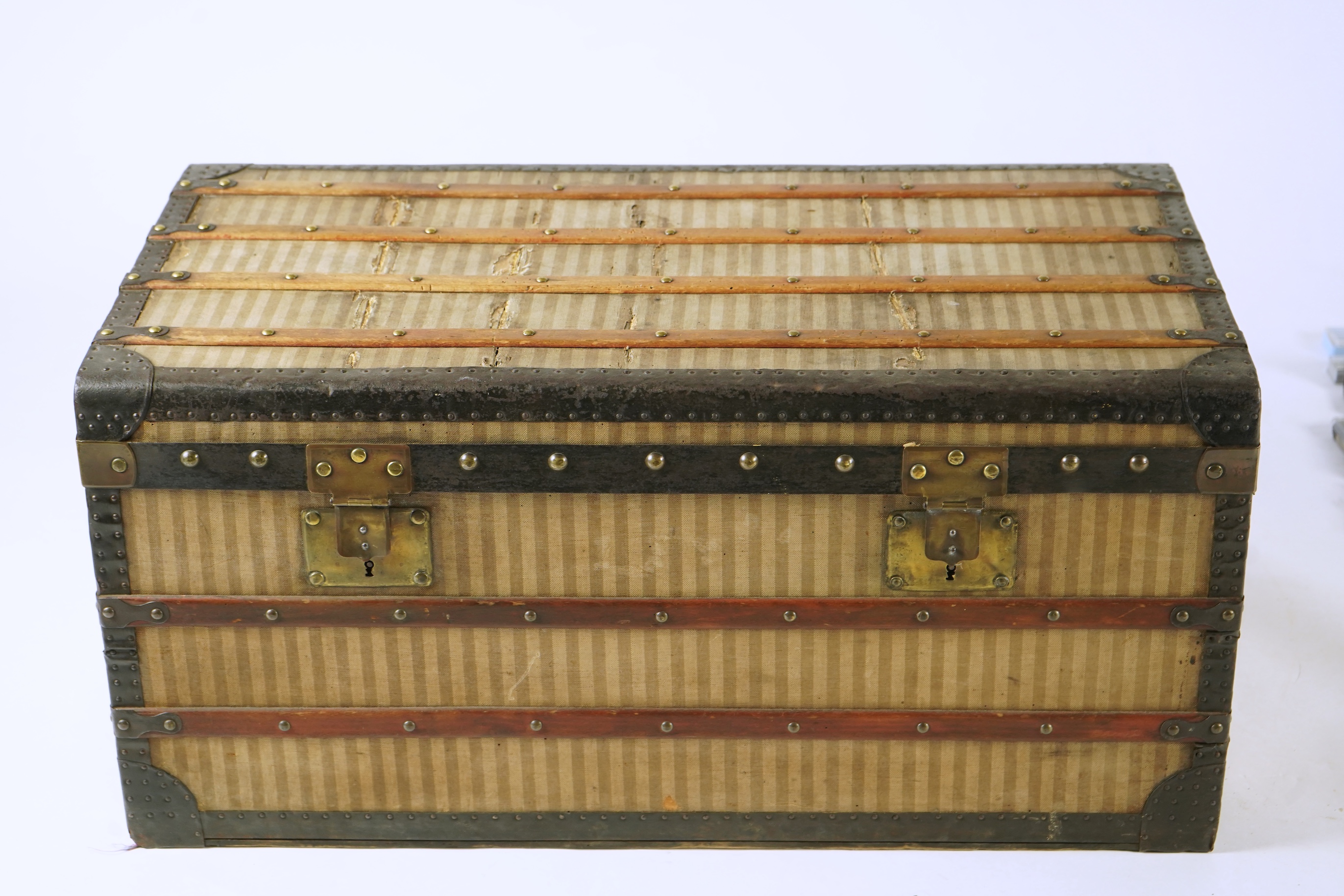 A vintage Louis Vuitton trunk with paper label to the interior numbered 142678, height 43cm, width 90cm, depth 48cm